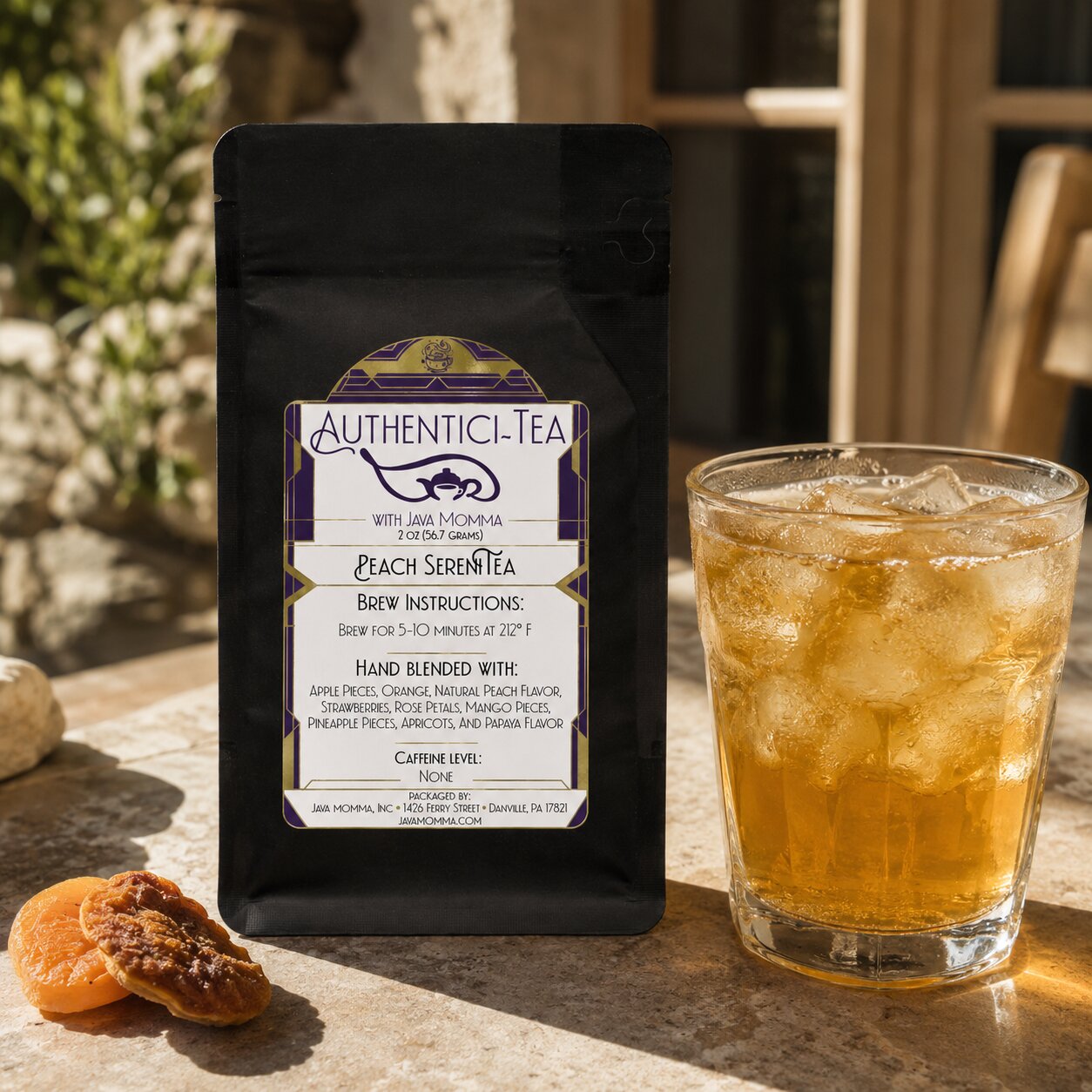 Authentici-Tea peach serenitea package with a glass of iced tea on a stone surface.