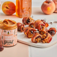 Thumbnail for A jar of Peach Vanilla Honey Cream Spread 🍑 – Sweet Summer Bliss in a Jar sits beside sliced peach and bacon-wrapped stuffed dates on a white cutting board, showcasing this creamy blend of peaches, vanilla, and honey.