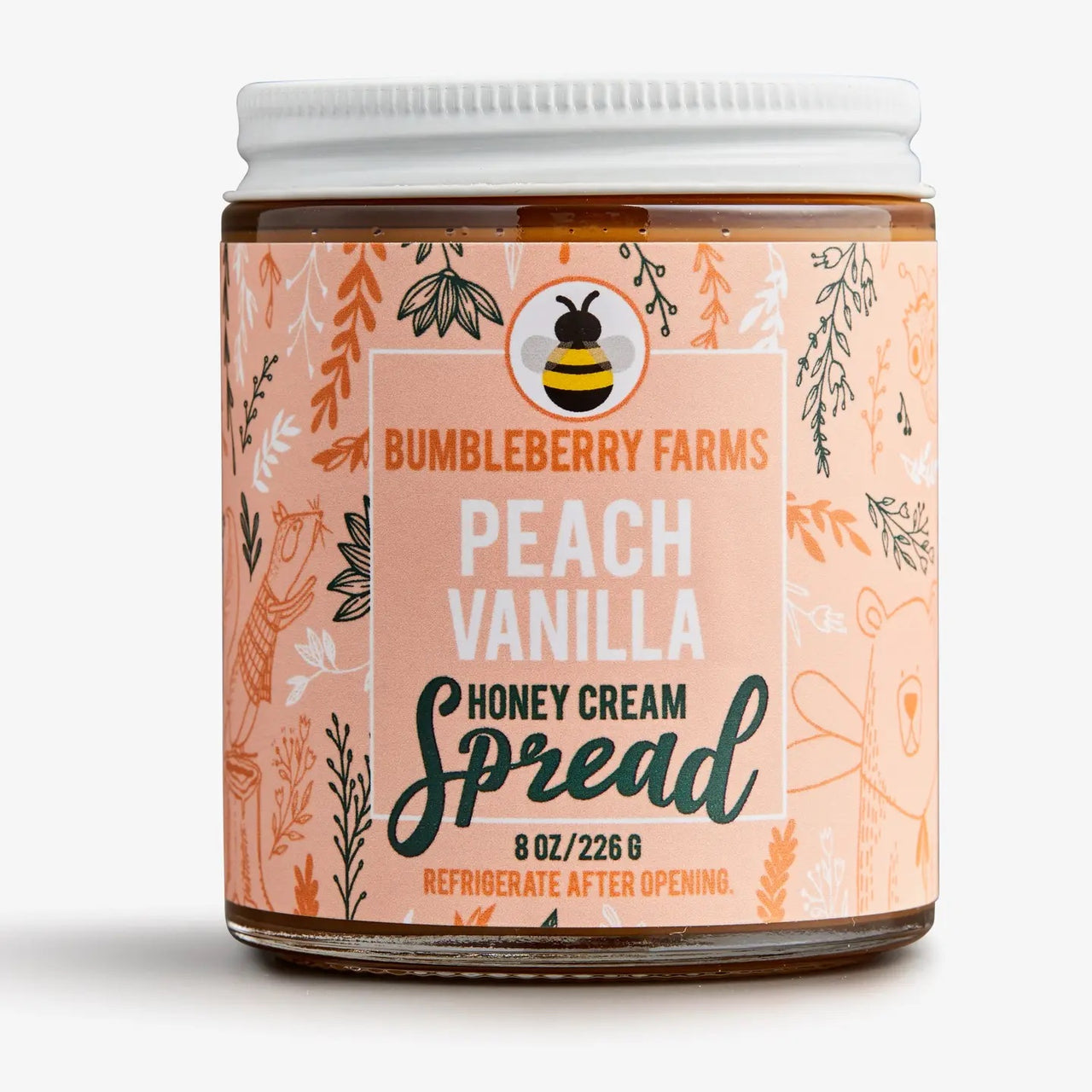 A jar of Peach Vanilla Honey Cream Spread 🍑 – Sweet Summer Bliss in a Jar, with a white lid and peach-colored, floral- and animal-illustrated label. This natural spread comes in an 8 oz (226g) jar—refrigerate after opening.