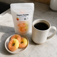 Thumbnail for Peachy Dried Candy package, cookies, and a cup of coffee on a marble surface
