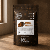 Thumbnail for Java Momma Peanut Butter Cup Donut flavored coffee bag on a warm wood surface