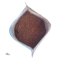 Thumbnail for An open bag of Pecan Praline – Buttery, Nutty Medium Roast coffee granules viewed from above, showing the rich brown coffee inside against a white background.