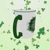 A St. Patrick’s Day mug spins in a 360-degree view, showcasing its festive design. The white mug features a bold green shamrock and the JavaMomma.com logo in elegant script, with a matching green handle and rim. As it rotates, the details of the design, smooth ceramic finish, and vibrant colors are fully visible, making it the perfect lucky mug for coffee lovers. 