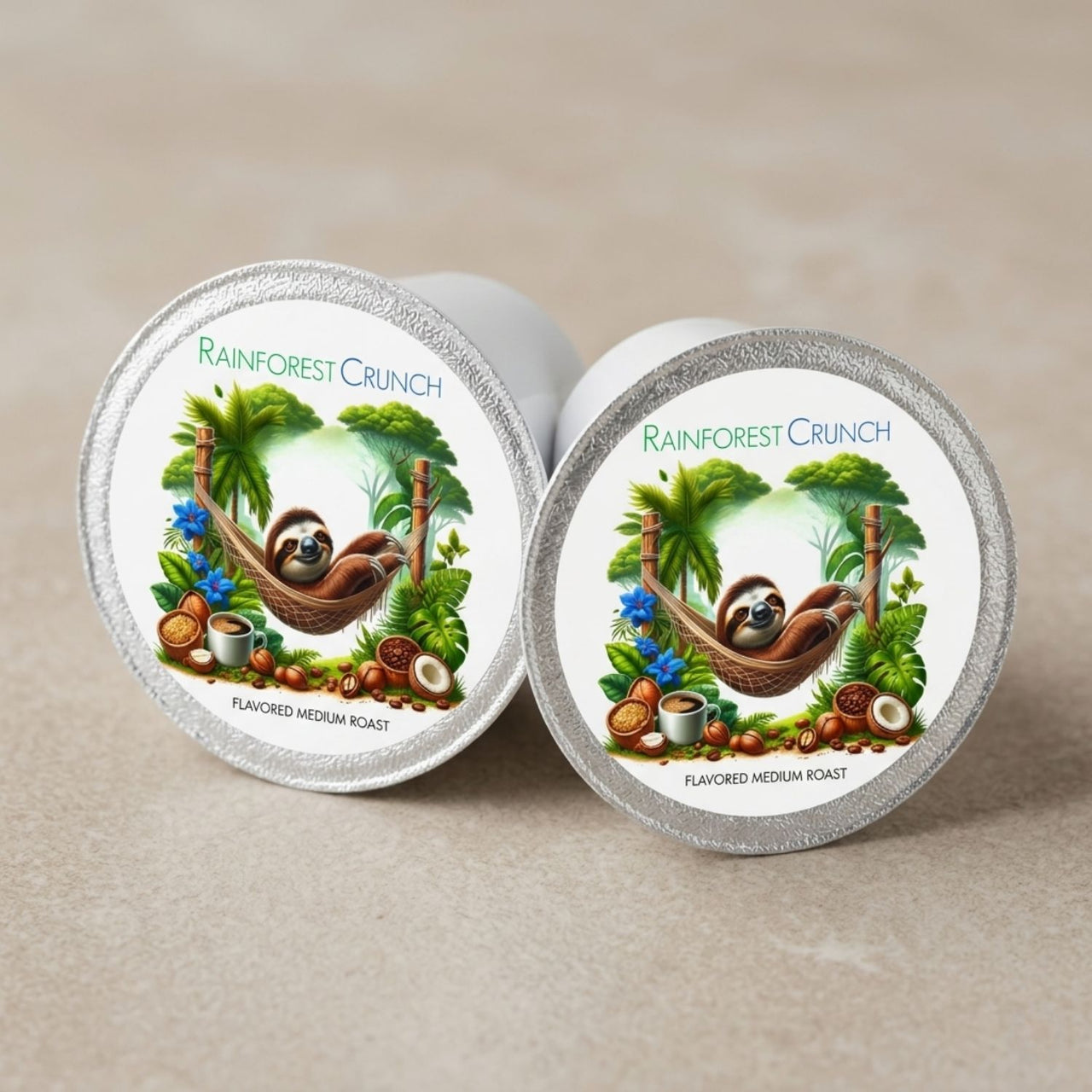 Two Rainforest Crunch coffee pods with sloth illustrations on a beige background