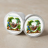 Thumbnail for Two Rainforest Crunch coffee pods with sloth illustrations on a beige background