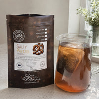 Thumbnail for Java Momma Salty Pretzel Cold Brew Pods bag beside a pitcher with a steeping mesh pod