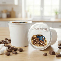 Thumbnail for S’moreadores single-serve coffee pods on a wooden surface with coffee beans and marshmallow accents