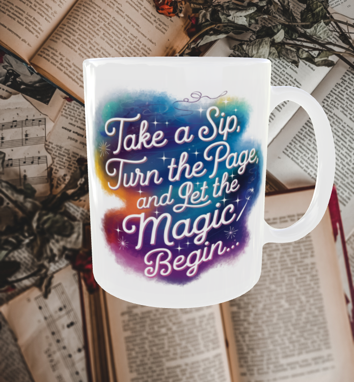 A white ceramic mug featuring the quote 'Take a sip, turn the page, and let the magic begin' in whimsical, storybook-style lettering with a colorful gradient background. The mug sits on an open book, creating a cozy reading and coffee-drinking atmosphere.