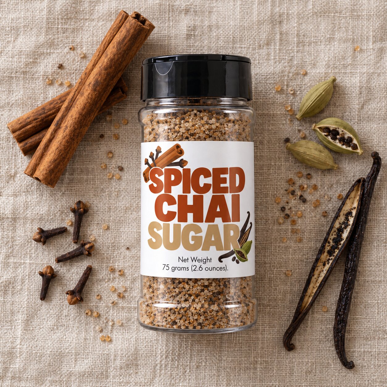 Spiced Chai Sugar Sprinkle jar with spices including cinnamon and cloves on a linen background.