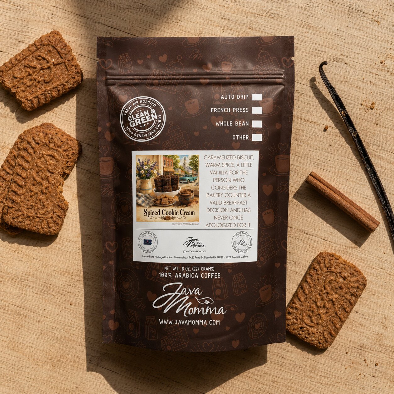 Java Momma Spiced Cookie Cream coffee package with cookies and vanilla beans on a wooden surface