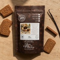 Thumbnail for Java Momma Spiced Cookie Cream coffee package with cookies and vanilla beans on a wooden surface