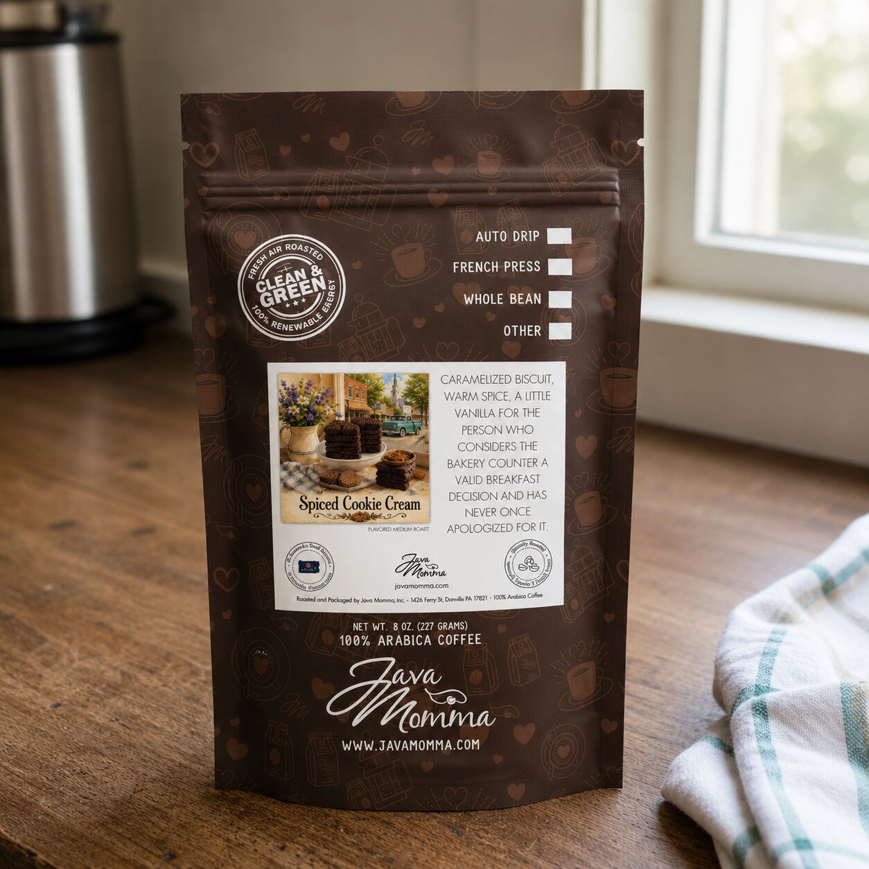 Spiced Cookie Cream Java Momma coffee package on a wooden surface with a kitchen background