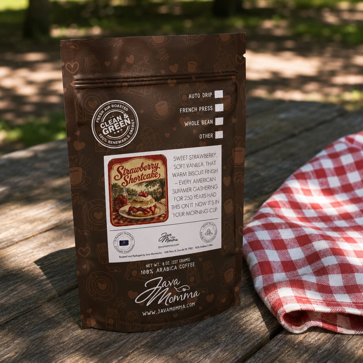 Strawberry Shortcake Coffee bag from Java Momma on a weathered wood picnic table
