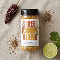 Thumbnail for Street Corn Seasoning Blend jar surrounded by spices and lime on a light background.
