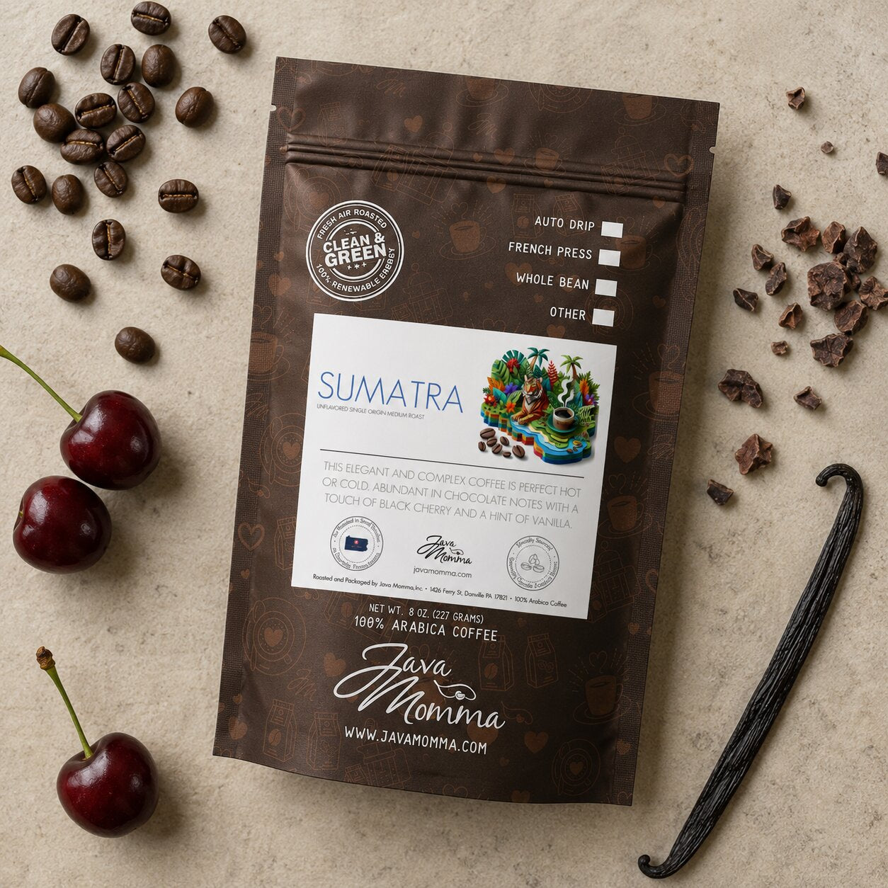 Overhead flatlay of Java Momma Sumatra Medium Roast coffee bag with whole coffee beans, cacao nibs, fresh cherries, and a vanilla bean pod