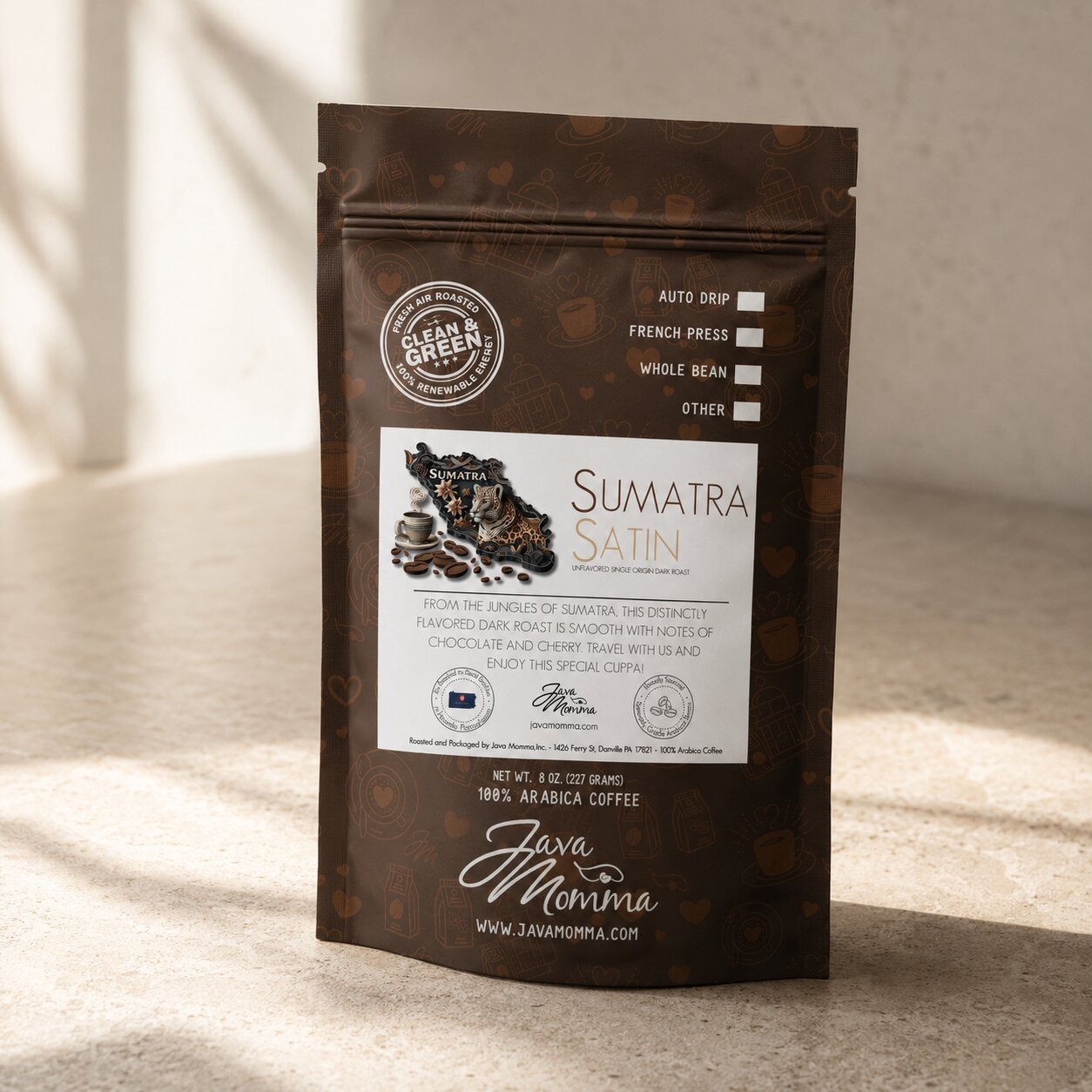 Bag of Java Momma Sumatra Satin Dark Roast coffee on a warm wood surface