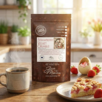 Thumbnail for Packaged coffee with strawberry velvet crumble flavor on a kitchen counter with a cup of coffee and dessert.