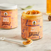 Thumbnail for An open jar of Sweet Maple 🍁 Honey Cream Spread – Cozy Maple Bliss in Every Bite sits on a marble surface with a spoonful beside it, showcasing the rich blend of maple syrup and wildflower honey; another closed jar is behind.