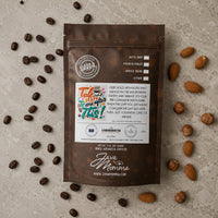 Thumbnail for Overhead flatlay of Java Momma Talk to Me After This coffee bag with whole coffee beans and toasted nuts