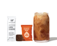 Thumbnail for A glass of iced pumpkin spice milk tea sits beside the Pumpkin Spice Latte Kit – Fall’s Coziest Tea Latte Gift Set 🎃☕🍁 Tea Drops, featuring latte creamer and tea cubes—perfect as a fall gift, displayed on a white background.