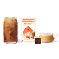 Thumbnail for A glass of iced pumpkin spice latte, a hot latte, a Pumpkin Spice Tea Drops cube, and the Pumpkin Spice Latte Kit – Fall’s Coziest Tea Latte Gift Set 🎃☕🍁 are arranged on a white background—perfect for cozy fall gifting.