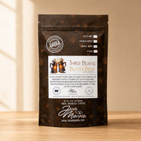 Thumbnail for Java Momma coffee package with 'Three Beans Butter Beer' flavor on a wooden surface.