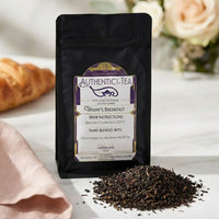 Thumbnail for black bag of Tiffany's Breakfast tea with tea spill on marble surface
