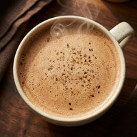 Thumbnail for A steaming cup of Vanilla Chaga Chai Latte with spices on top, perfect for cozy moments.