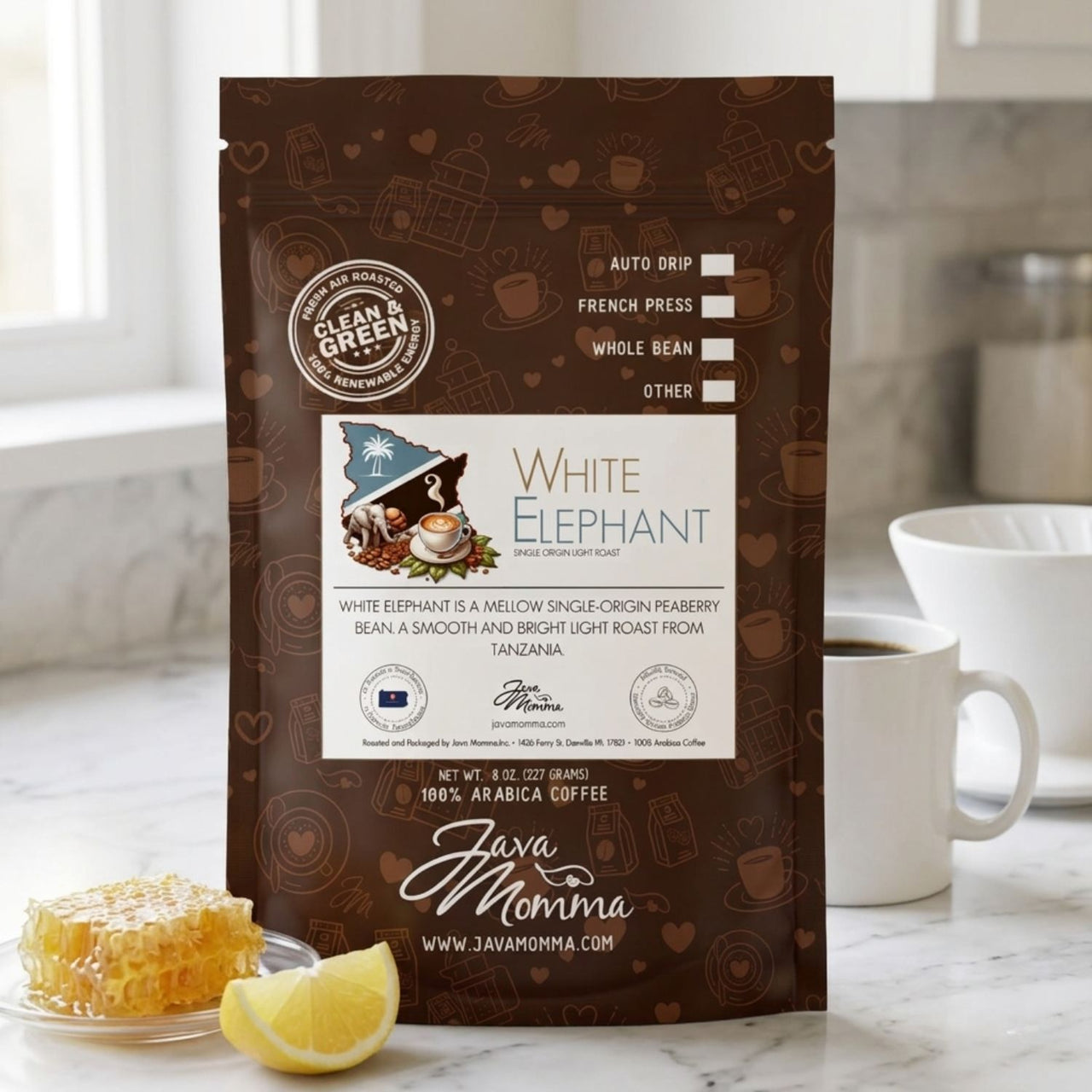 Java Momma White Elephant coffee bag beside a pour-over dripper and filled ceramic mug